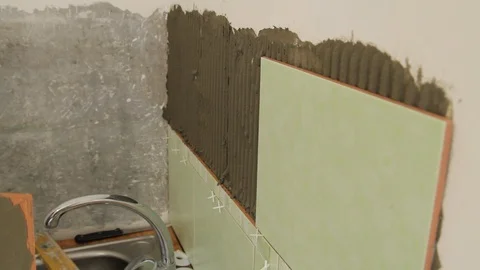 Master glues the tile on the wall. Stock Footage 101685493