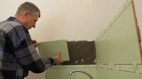 Master glues the tile on the wall. Stock Footage 101685567