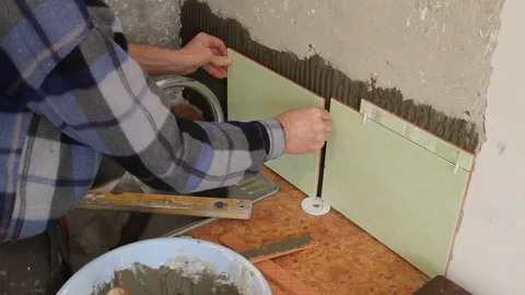 Master glues the tile on the wall. Stock Footage 101685578