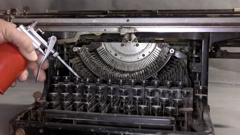 The master greases the old typewriter. Stock Footage 139385517