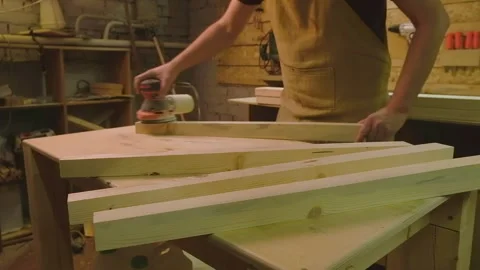 The master grinds the boards cut with a circular saw with a grinding machine Stock Footage 182226061