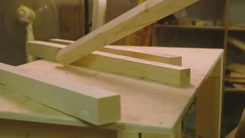 The master grinds the boards cut with a circular saw with a grinding machine Stock Footage 182226231