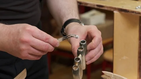 Master hand puts small detail into airplane engine model Stock Footage 127375389