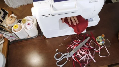 Master of handmade made clothes for doll on sewing mashine. Top view. Stock-Footage 81593591