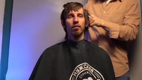 Master hands hold instruments and perform hairstyle for guy. timelapse Stock Footage 132893997