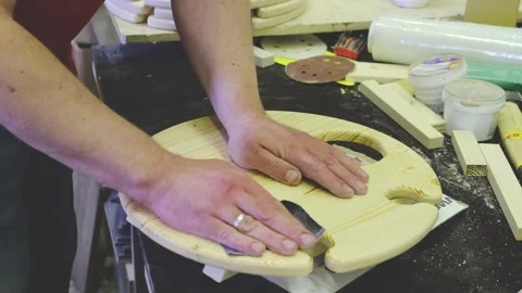 Master hands hold sandpaper and polish wooden part closeup Stock Footage 135443322