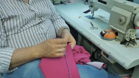 Master hands while sewing new clothes Stock Footage 94157552