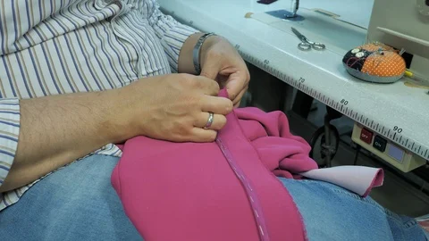 Master hands while sewing new clothes Stock Footage 94157581