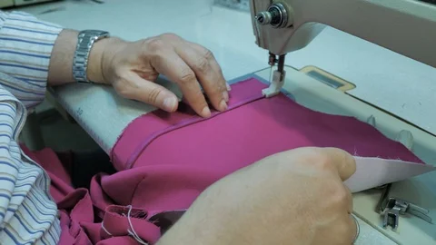 Master hands while sewing new clothes Stock Footage 94157991