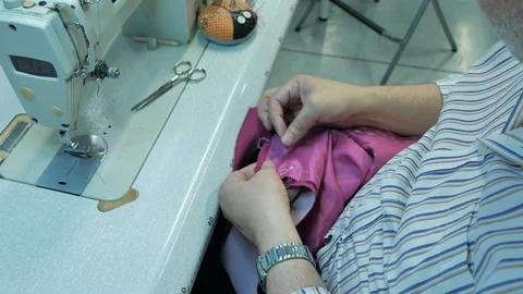 Master hands while sewing new clothes Stock Footage 94158223
