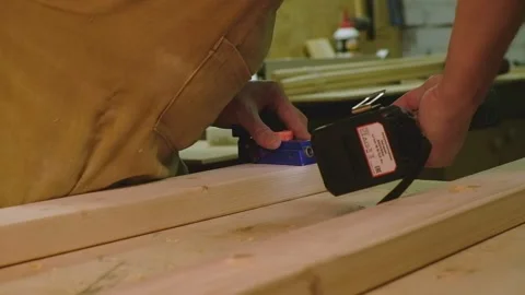 The master, with the help of a conductor, screws the screws into the parts wi Video stock 182223132