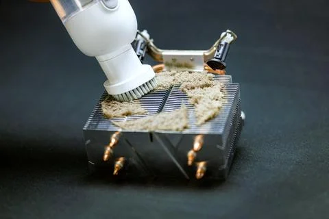 The master with the help of a vacuum cleaner removes dust and dirt from the r Stock Photos