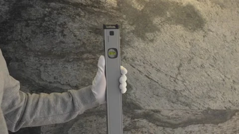 The master holds a bubble level in his hands. Stock Footage 258470745