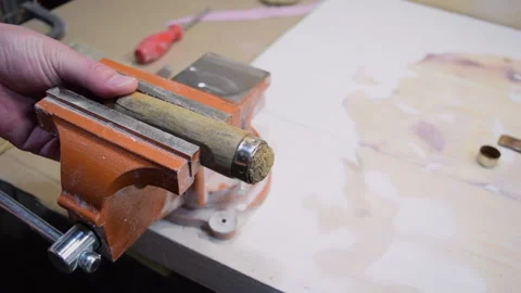 The master holds the handle of an old chisel in a vise. Stock Footage 155883783