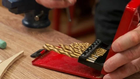 Master holds special red plastic box and inserts small drill Video stock 127377442