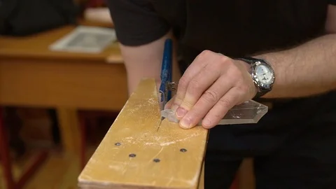Master holds transparent plexiglass on brown wooden support Stock Footage 127113386