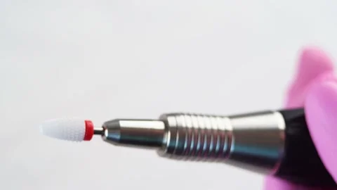 Master is inserting a milling cutter for removing gel nail polish Stock Footage 196223154