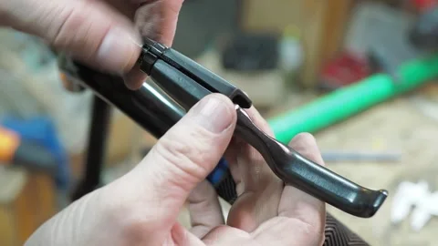 The master inserts the brake cable into the bicycle brake. Video stock 317499337