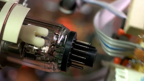 The master inserts the connector into the electronic gun of the old TV Video stock 73907919