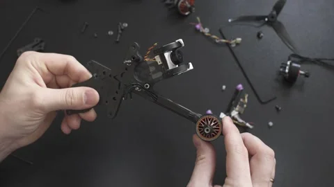 Master inspects the frame of a broken FPV drone Stock Footage 149774196