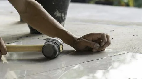 Master installer laying tile, Tile work and construction. Stock Photos