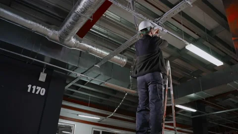 Master is installing electric box, connecting industrial equipment in plant Stock-Footage 157230519