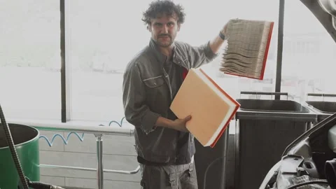 The master installs the air filter in the car Stock Footage 139559233
