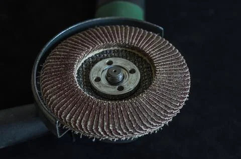 The master installs the cutting wheel in the angle grinder	 Stock Photos