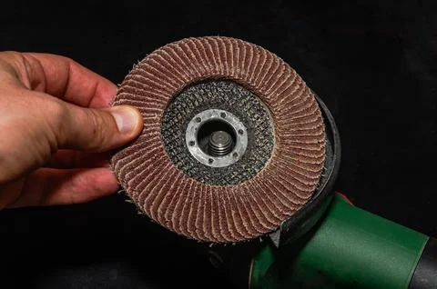 The master installs a disc on an angle grinder Stock Photos