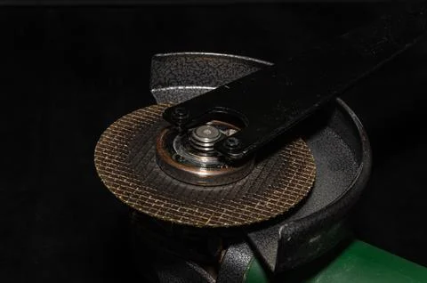 Master installs a disc on an angle grinder Stock Photos