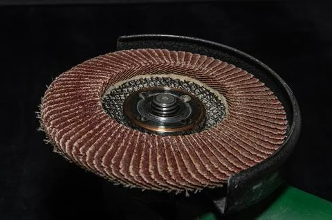 Master installs a disc on an angle grinder Stock Photos