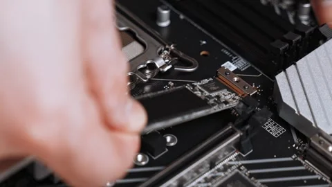 Master installs SSD m2 sata on motherboard. motherboard during custom PC Video stock 300192878