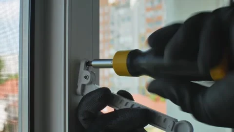 The master installs a window opening lim... | Stock Video | Pond5