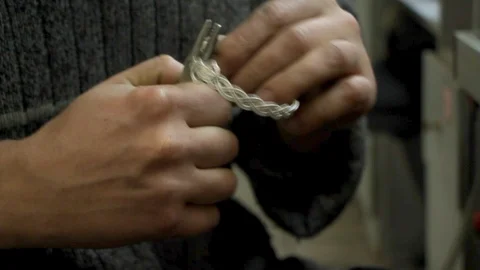 The master jeweler holds the working tool in his hands and makes jewelery Stock Footage 126726698
