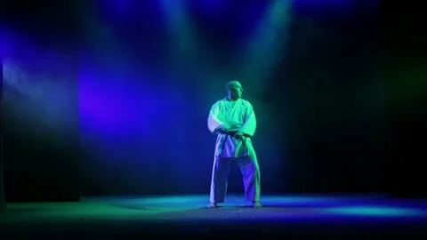 Master karate background with colored smoke is engaged in karate Stock Footage 93960634