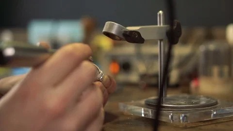 Master keeps jewelry and processes the edges of the product Stock Footage 72966979