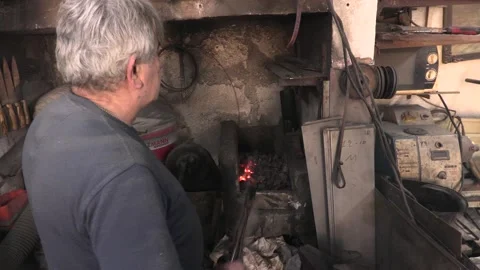 Master knife blacksmith Michael Paxtikos working in his knife workshop. Stock Footage 195810214