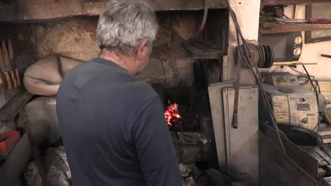 Master knife blacksmith Michael Paxtikos working in his knife workshop. Stock Footage 195812554