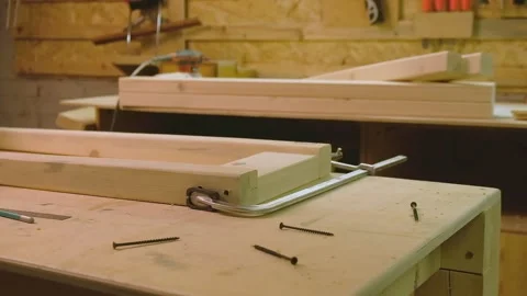 The master knocks with a hammer on the boards fastened with a clamp to give g Video stock 182224455