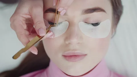 Master lash maker increases eyelashes for young women Stock Footage 172578592