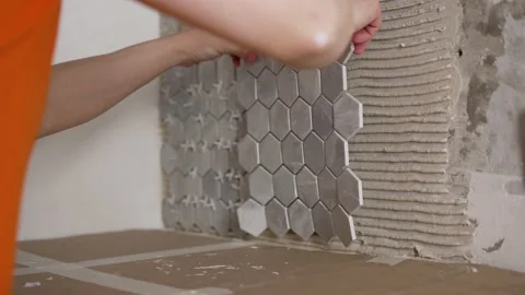Master in lays ceramic tiles on the wall in the kitchen. Stock Footage 195093725