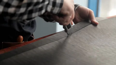 A master from a leather rudder cuts billets to make a belt. Procedure for the Stock Footage 86659006