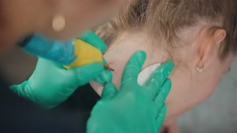 Master make tattoo on neck of client with help machine and wipe paint napkin. Stock Footage 219549389