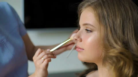 The master in a make-up trains the student for final. The girl puts a brush Stock Footage 91870469