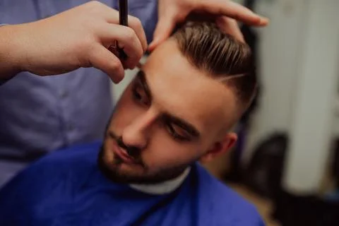 Master makes beards correction in barbershop salon. Close up photo. Stock-Fotos