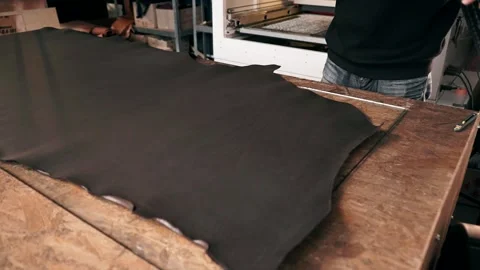 The master makes a cut for sewing a leather bag Stock Footage 151207804