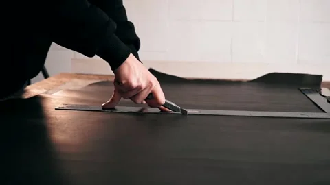The master makes a cut for sewing a leather bag Stock Footage 151207814