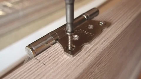 Master makes doors-hinge screwing. Stock Footage 100668622