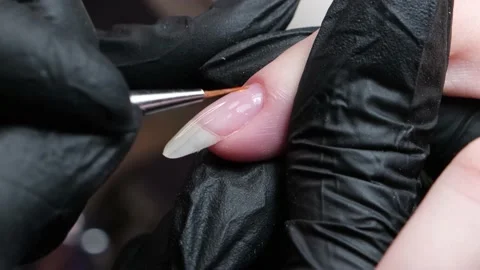 The master makes hygienic manicure to the client in the nail salon. The process Stock Footage 133966073