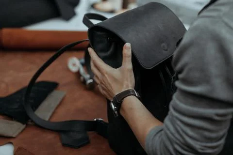 The master makes a leather bag. A close up, a product from skin in hands. Stockfoto's